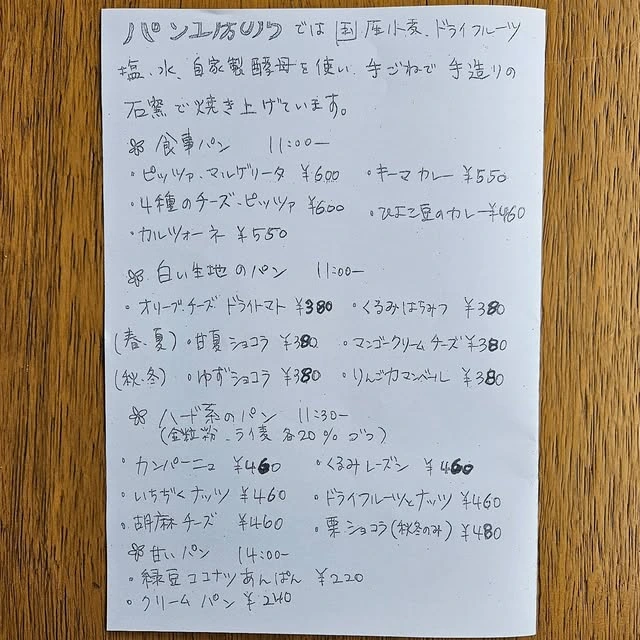 パン工房のらの手書きメニュー表。食事パン、白い生地のパン、ハード系、甘いパンの価格と焼き上がり時間